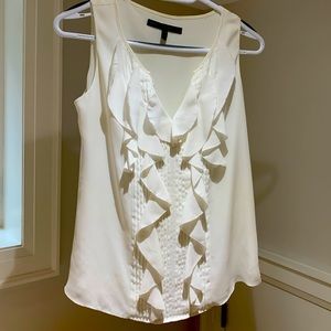 Sleeveless White House Black House ruffled top.